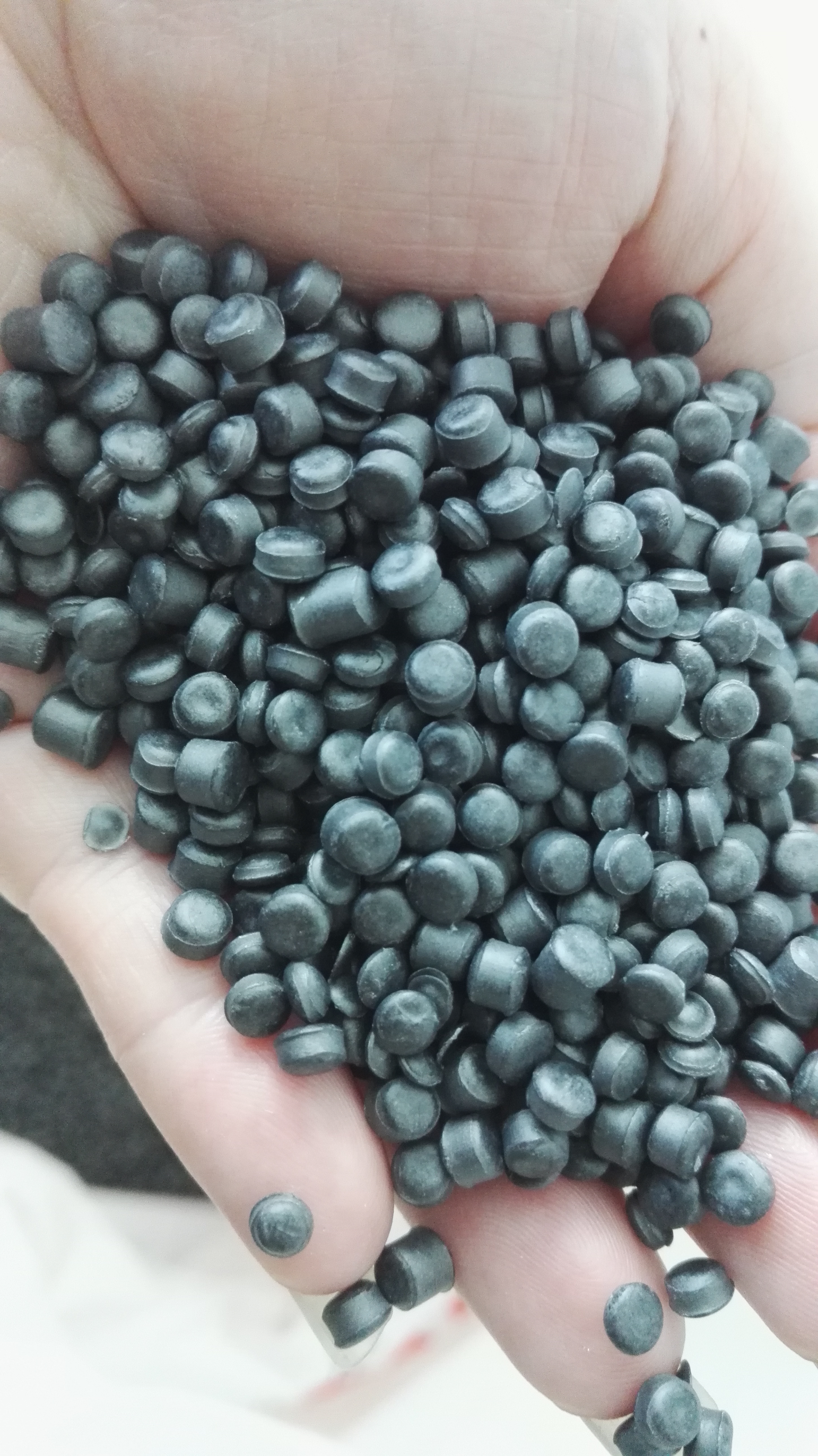 Colored plastic pellets including glass-fiber reinforced nylon grades used as feedstock in injection molding