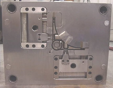 B-side of an injection mold die showing cavity inserts and side pulls built from tool steel