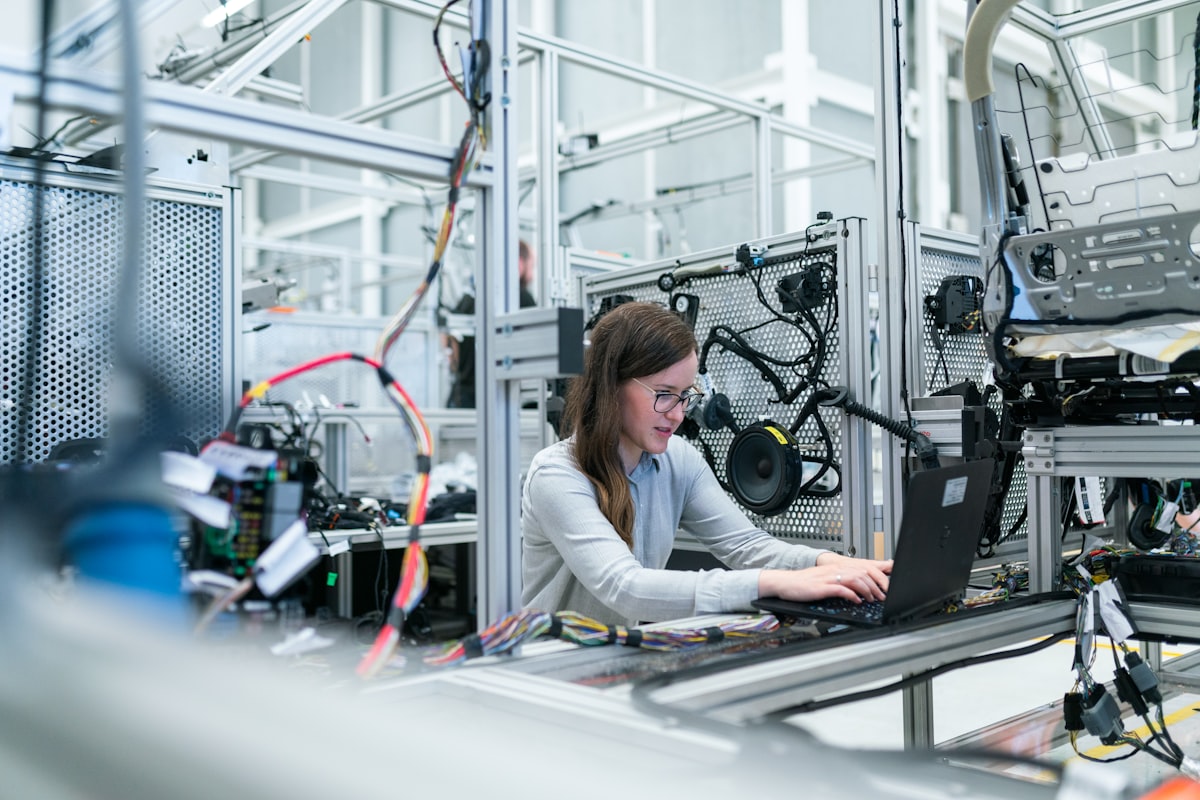 Quality engineer reviewing injection-molded automotive parts on a dimensional inspection table